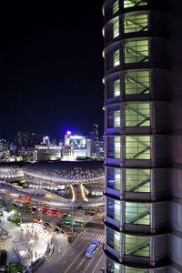 Illuminated city street and buildings at night