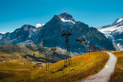 Scenic view of snowcapped mountains against blue sky