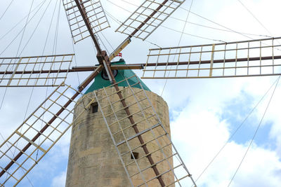 Low angle view of traditional windmill against sky