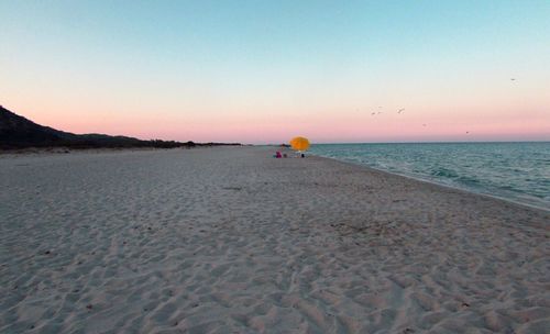 Scenic view of beach at sunset