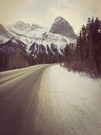 Road passing through snowcapped mountain