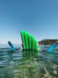 Multi colored umbrella on swimming pool against sea