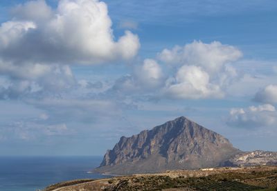 Scenic view of sea and mountains against sky