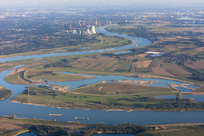Aerial view of river and cityscape against sky