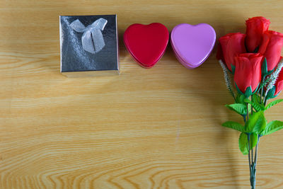 Directly above shot of red rose on wooden table