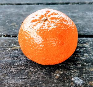 Close-up of orange apple on table