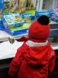 Rear view of girl looking at toys in store