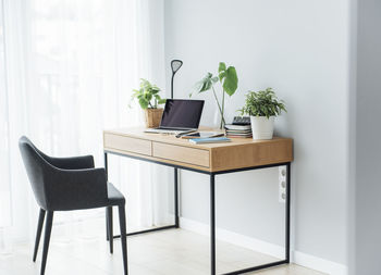 Office workplace with laptop on wooden table