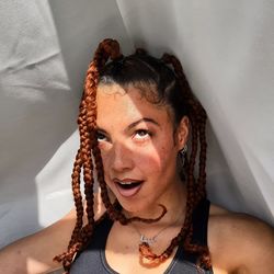 Portrait of woman at home with natural braided hair