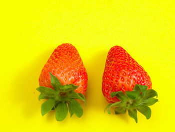 Close-up of fruits against yellow background