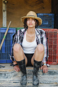 Portrait of young woman sitting outdoors