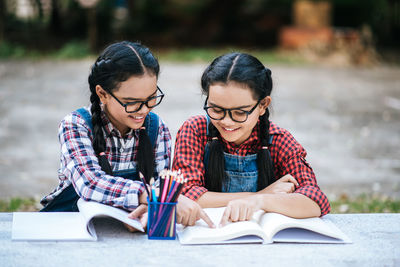 Portrait of young woman on book