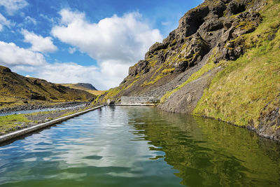 Idyllic view of seljavallalaug natural geothermal hotspring pool by mountain