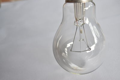 Close-up of light bulb against white background