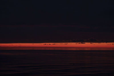 Scenic view of sea against orange sky