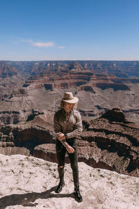 Full length of man standing on mountain against sky