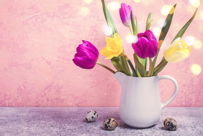 Close-up of pink roses in vase on table