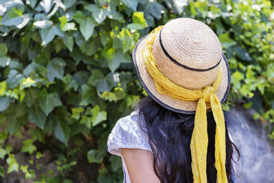 Rear view of woman wearing hat standing outdoors