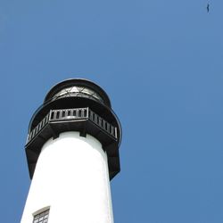 Low angle view of water tower against clear blue sky