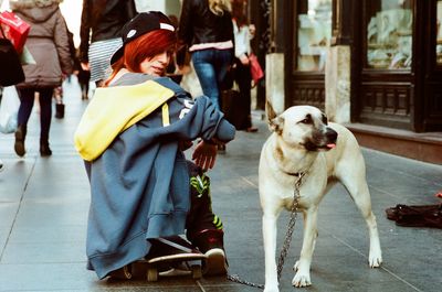 Rear view of man with dog in city