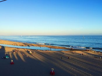 Scenic view of beach against clear blue sky