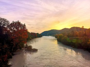 Scenic view of river against sky during sunset