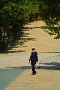 Full length of man walking on footpath