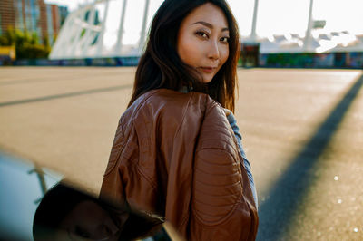 Portrait of young cool asian woman in coat