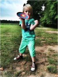 Boy standing on field in park