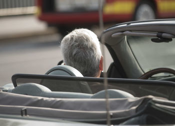 Rear view of man sitting in car