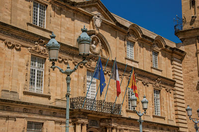 Close-up facade of the city hall with flags at aix-en-provence, in the french provence.