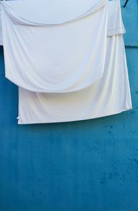 Clothes drying against white wall