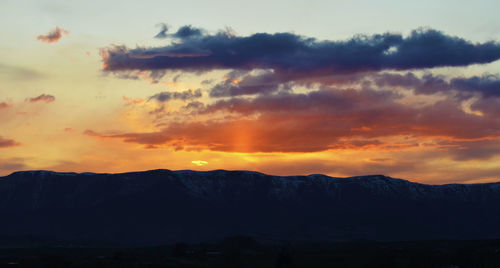 Scenic view of silhouette mountains against sky during sunset