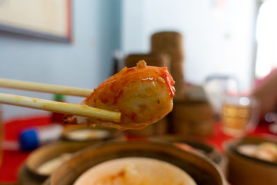 Close-up of hand in plate on table