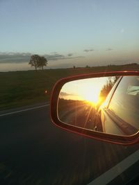 Sunset reflecting on side-view mirror