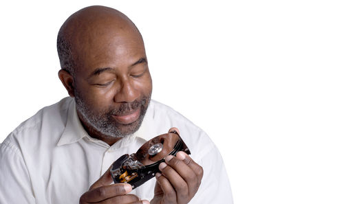 Portrait of a man holding ice cream against white background