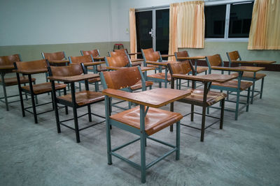 Empty chairs and table in building