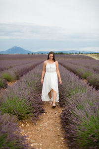 Full length of woman standing on land against sky