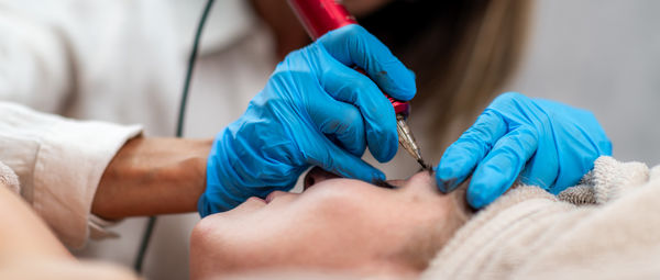 Midsection of doctor examining patient in hospital