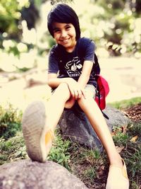 Portrait of smiling girl sitting on grass