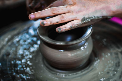 Close-up of artist making pot at workshop