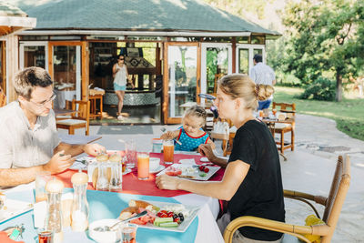 Rear view of people sitting at table