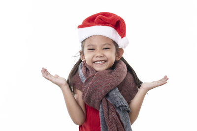 Portrait of smiling girl wearing hat against white background