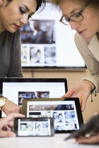 Creative businesswomen using various technologies in office