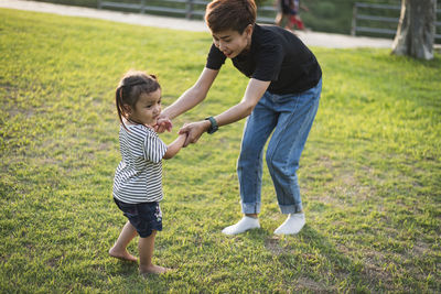 Side view of woman exercising on field