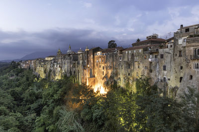 Panoramic shot of illuminated buildings against sky