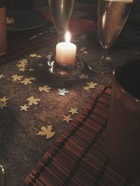 High angle view of illuminated candles on table