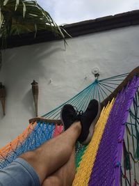 Low section of woman lying on hammock