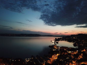 Scenic view of lake against sky at night