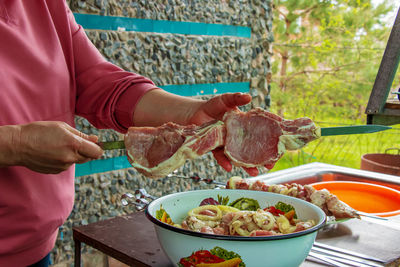 Midsection of man preparing food